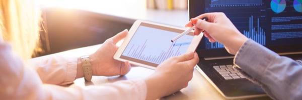 Man and woman looking at data on an iPad Man and woman looking at data on an iPad